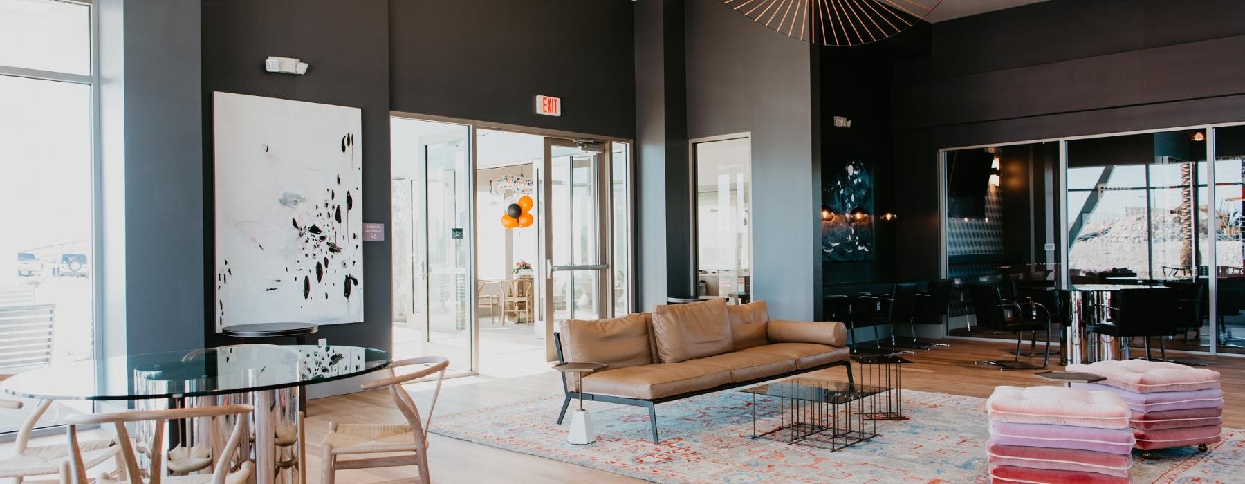 a room with a couch and chairs