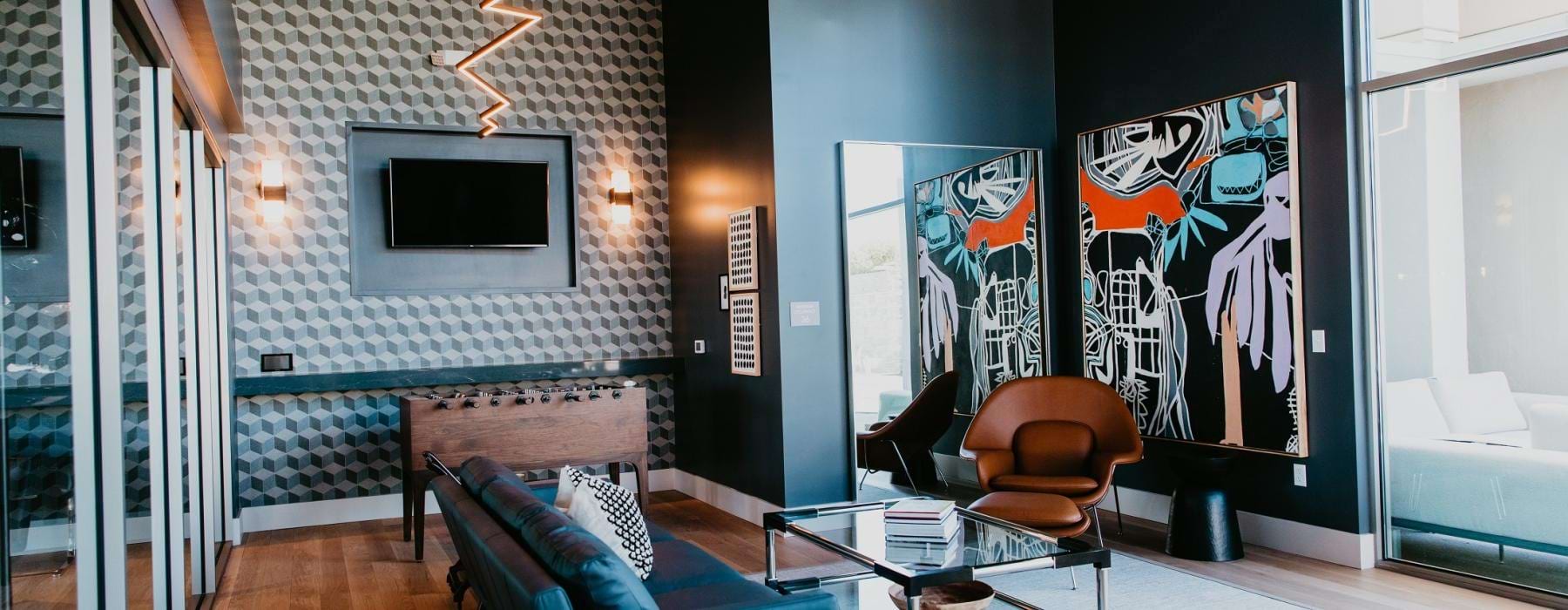a living room with a tv and chairs