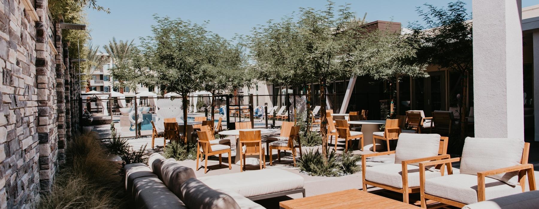 a patio with tables and chairs