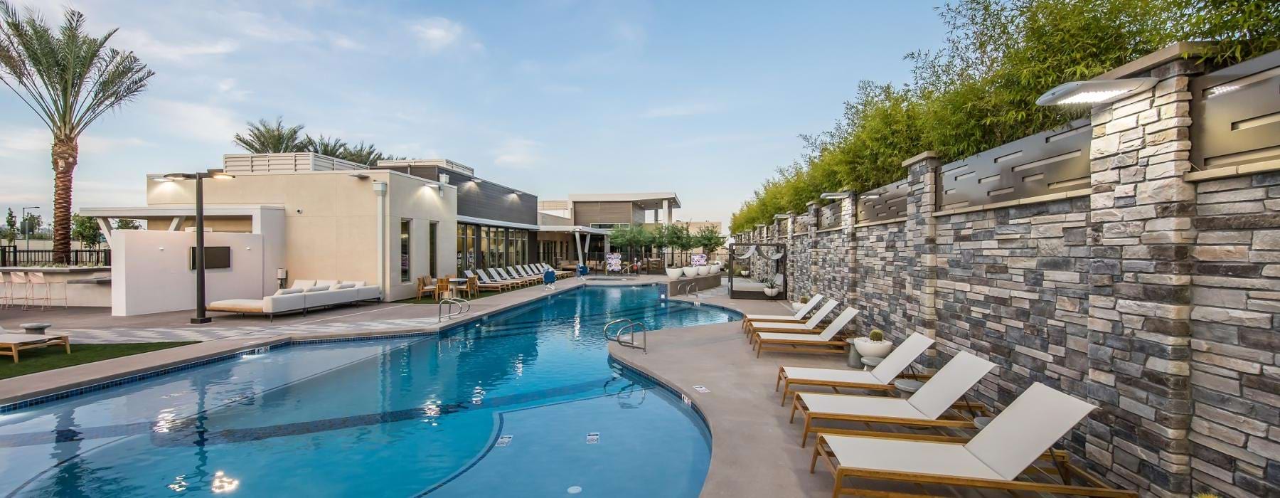 a swimming pool with a stone wall